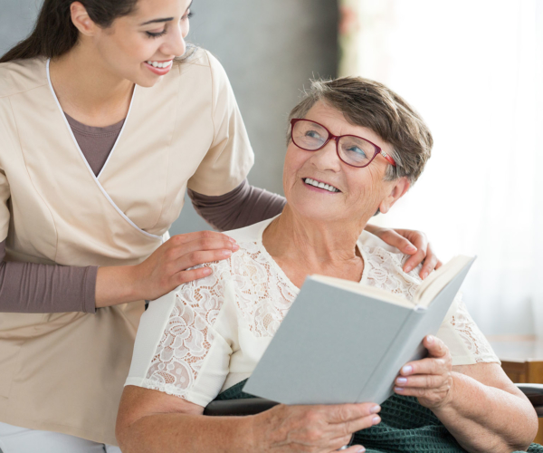 Smiling grandma reading book Senior Caregivers Boca Raton
