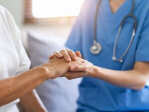 Nurse holding a Seniors hands